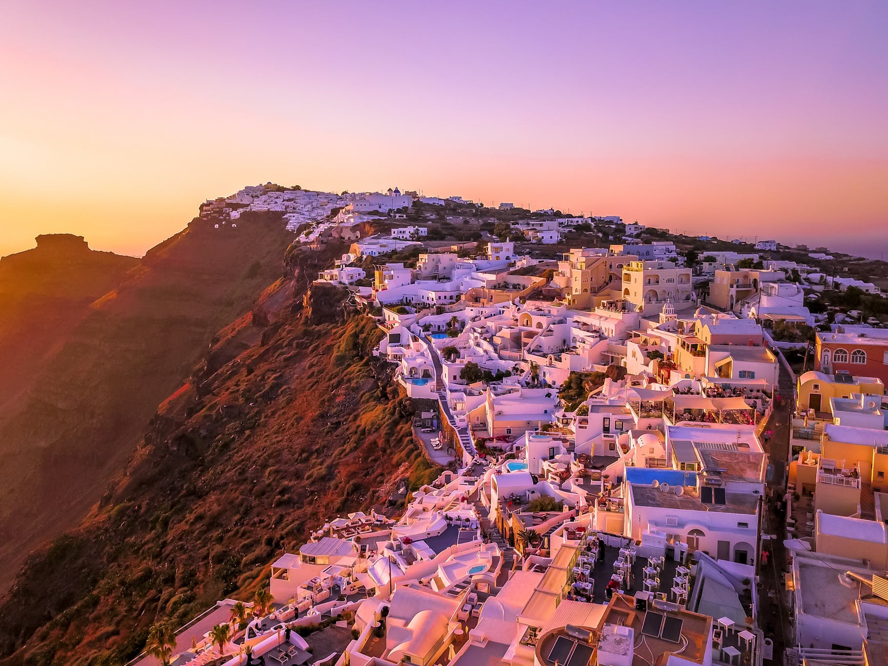 Greek city on a mountain at sunset.