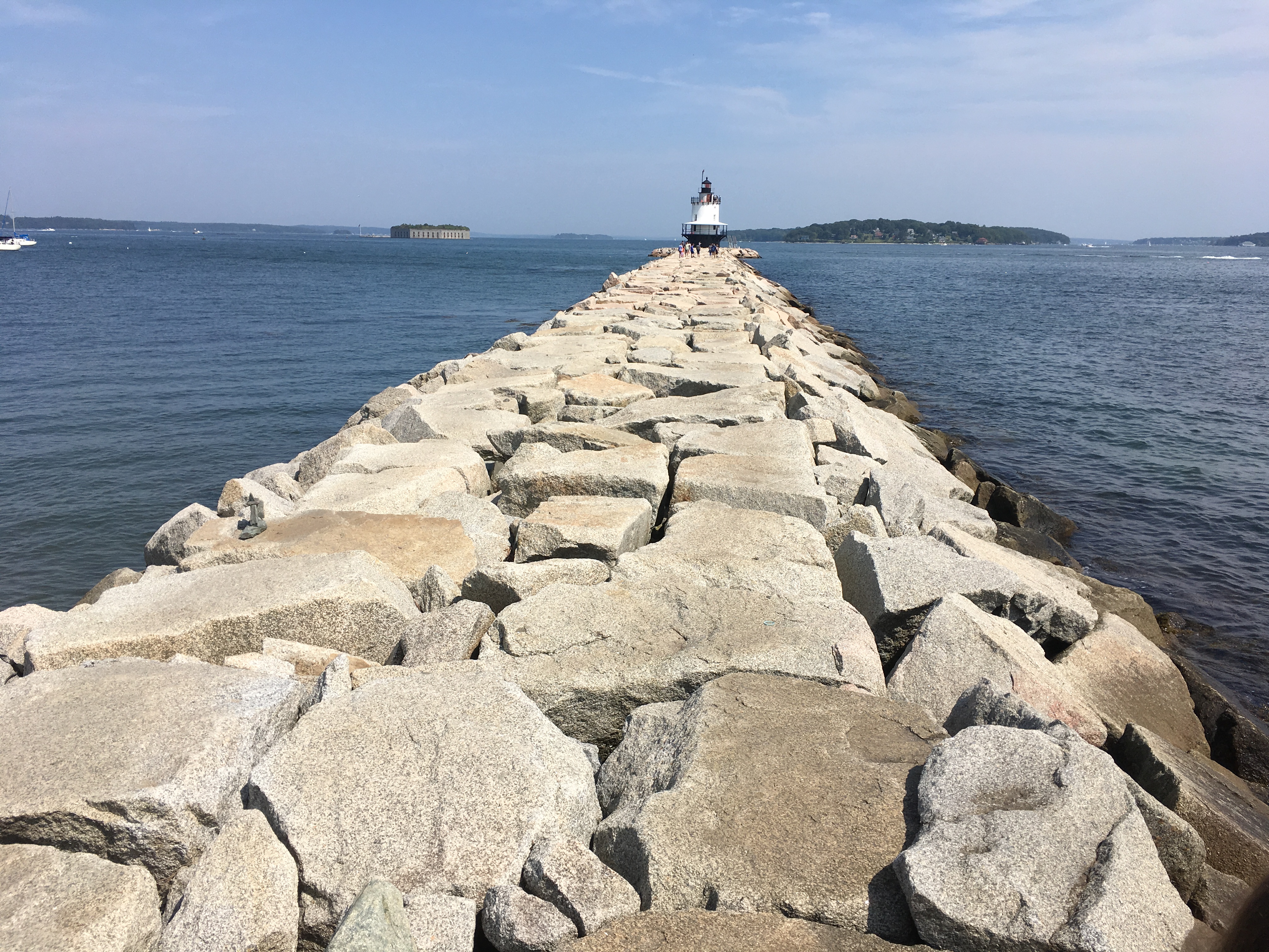 Rocky pier that leads to a lighthouse.